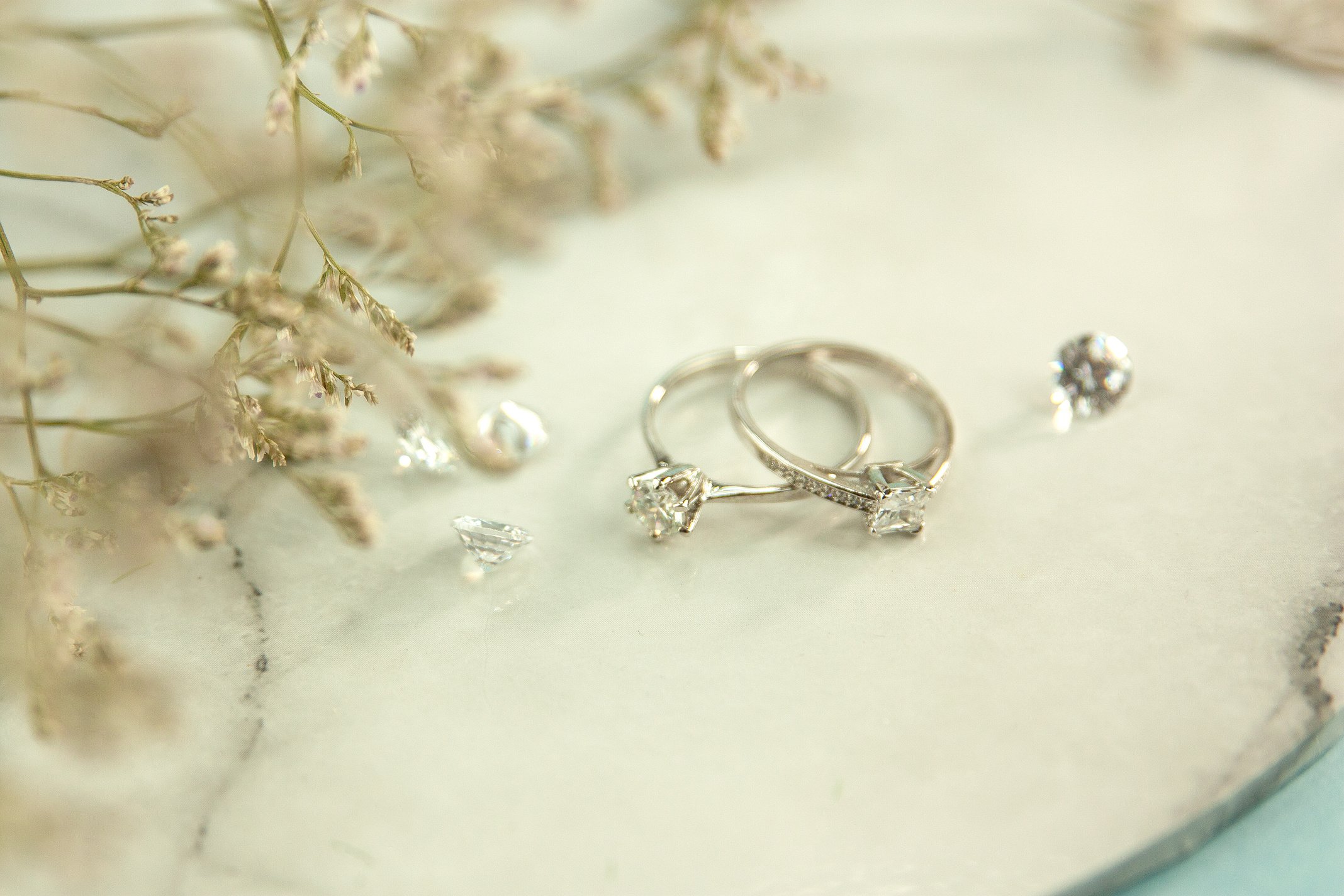 Engagement rings placed near twigs